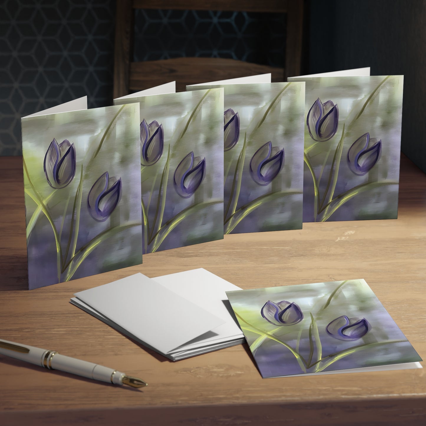 5-pack of Purple Tulip Passion Greeting Cards featuring the stunning Passion painting by Arlene Passarella from her bestselling Floral Awakening collection. Colors are Purple, Green and Yellow. On desk.