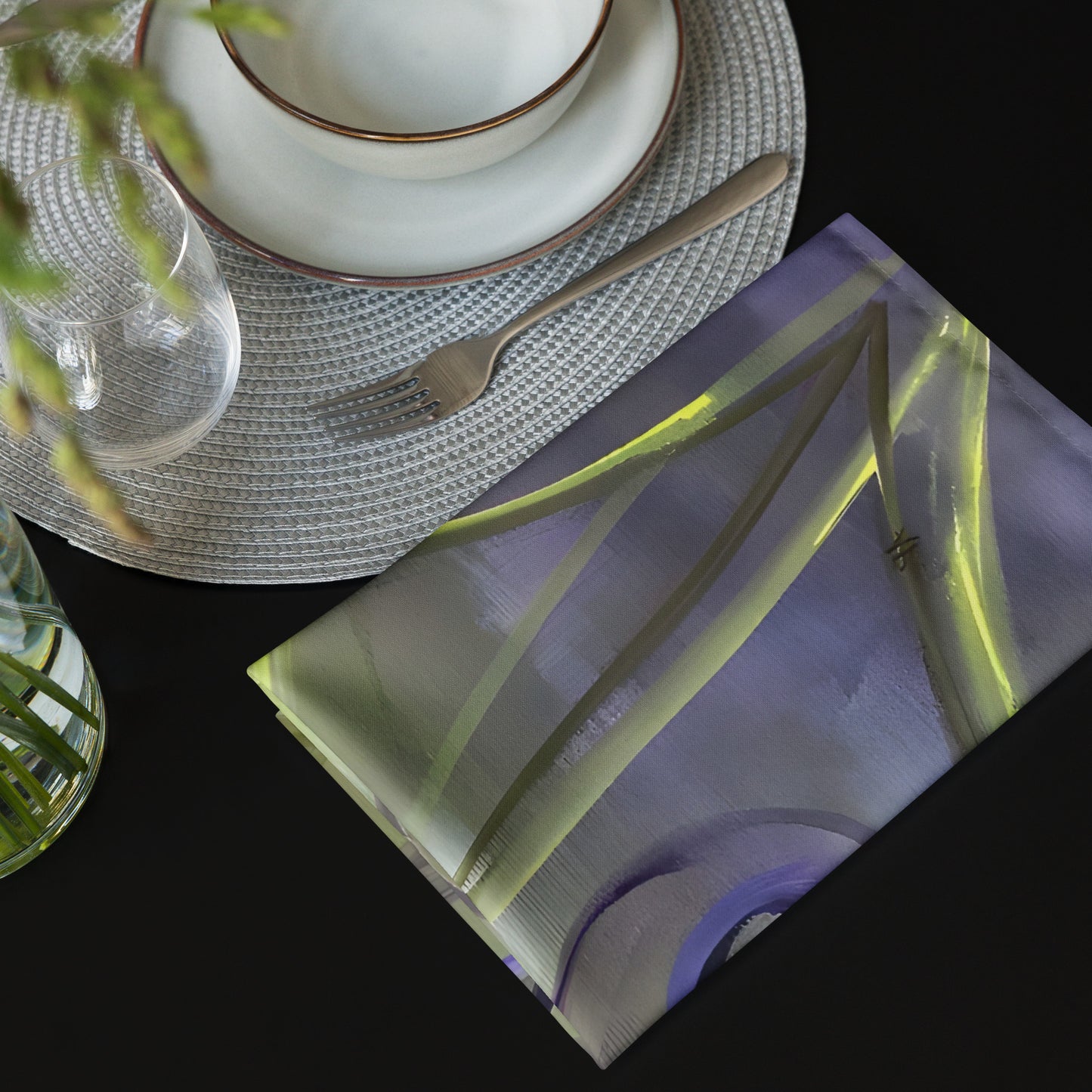Purple-tulips-on-green-yellow-background-Passion-Cloth-Napkin-by-painter-Arlene-Passarella-from-her-Floral-Awakening-Collection-one-napkin-on-black-table