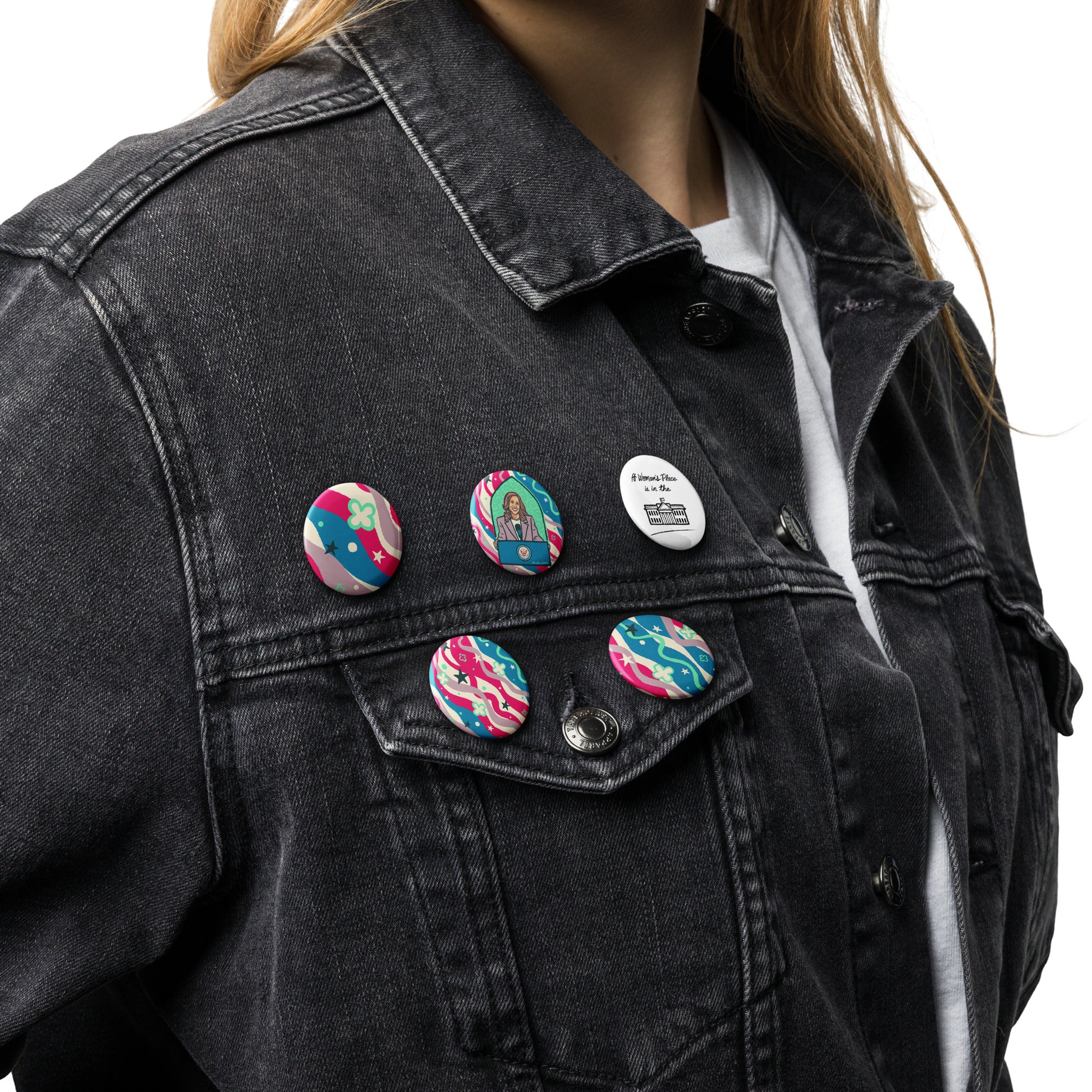 Set of five bold, colorful pin buttons, with primary colors red and blue, featuring the art of award-winning artist Charlene Potts.The featured art is from her KamalaSphere — A Woman's Place Is collection for Give ilo!